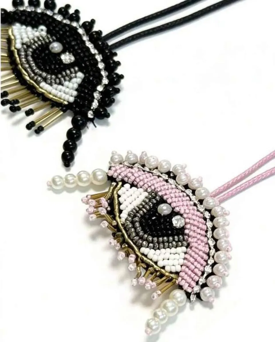 Pink and black beaded eye charms