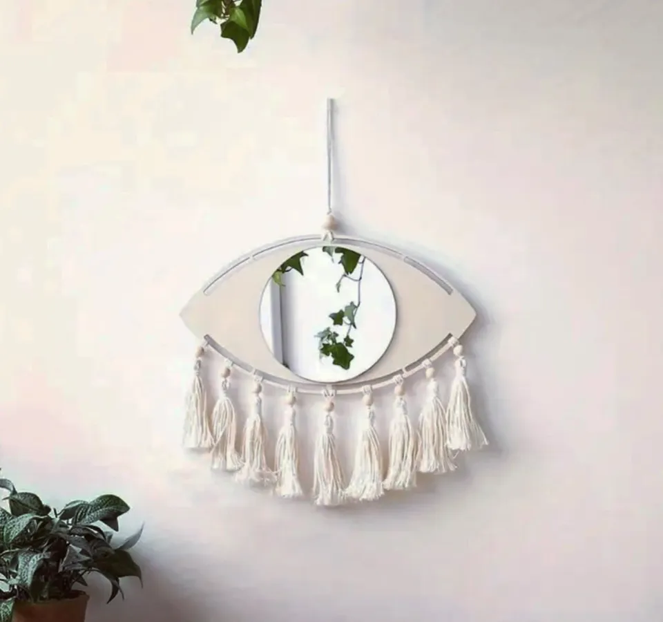 Eye-shaped mirror wall hanging with tassels