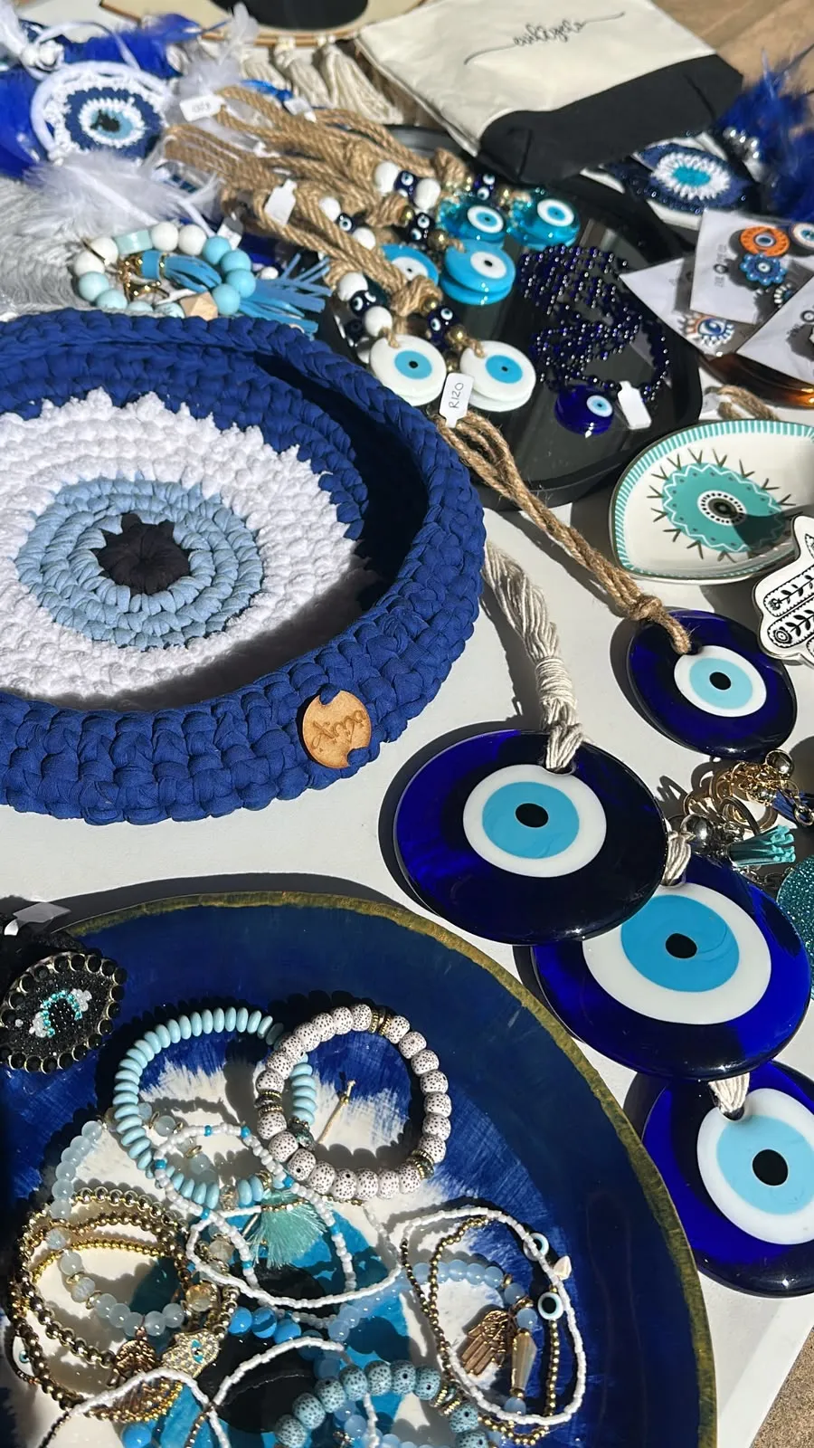 Evil eye pieces laid out at our market stall
